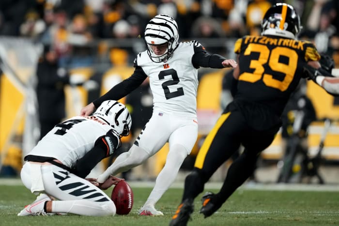 Cincinnati Bengals place kicker Evan McPherson (2) kicks a field goal as Cincinnati Bengals punter Drue Chrisman (4) holds in the third quarter during a Week 11 NFL game against the Pittsburgh Steelers, Sunday, Nov. 20, 2022, at Acrisure Stadium in Pittsburgh, Pa. The Cincinnati Bengals won, 37-30. Nfl Cincinnati Bengals At Pittsburgh Steelers Nov 20 0071